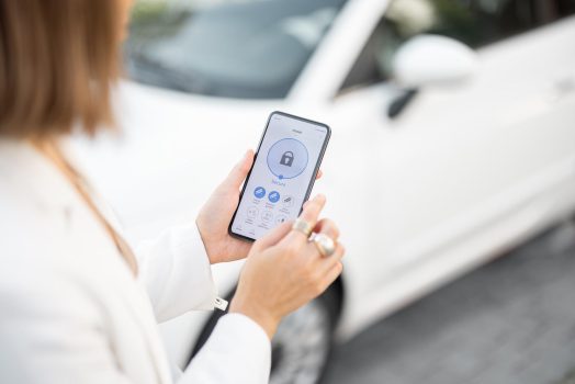 Woman control car alarm with mobile phone